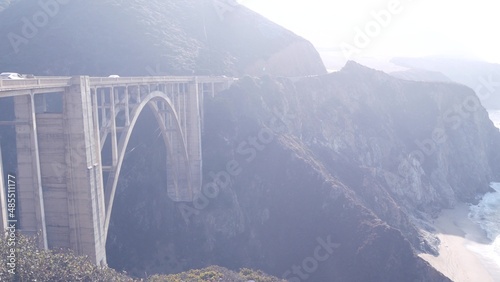 Bixby creek bridge, arch architecture. Pacific coast highway 1 landmark. Historic scenic Cabrillo road. Coastal road trip, journey or travel by ocean. Canyon in foggy weather. California, Big Sur, USA