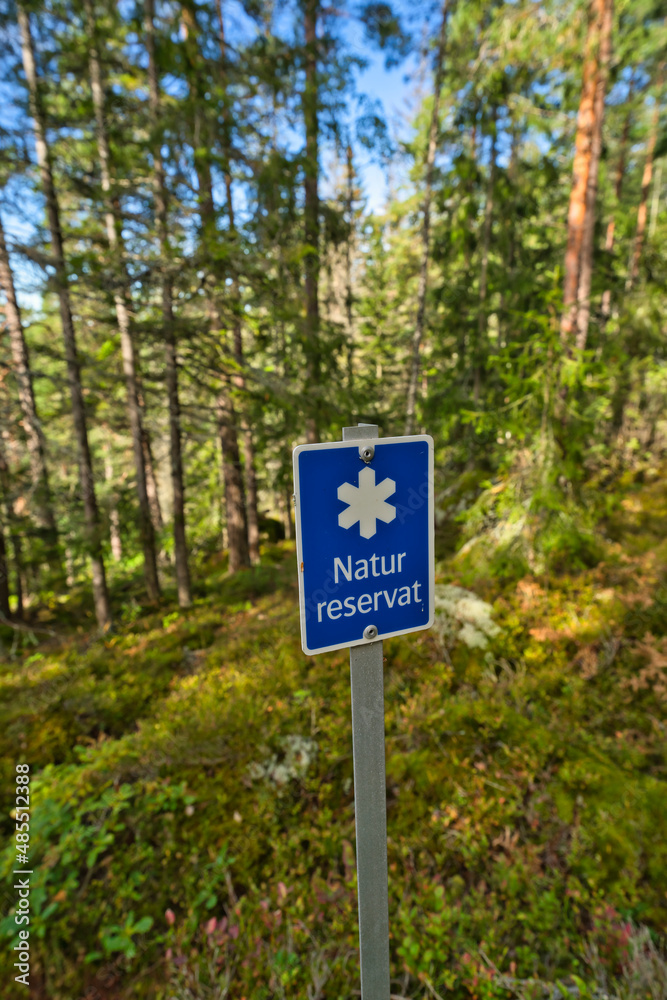 Nature reserve sign in front of forest in sweden