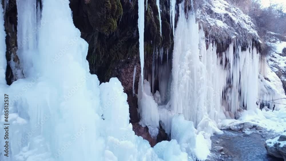 Slow motion canon with frozen waterfalls. Slow motion near beautiful icicles, ice floes in arctic nature. Freezing water in nature Slow motion canon with frozen waterfalls. Slow motion near beautiful icicles, ice floes in arctic nature. Freezing water in nature