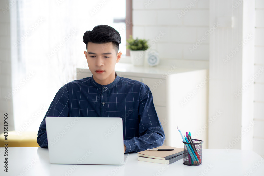 Young business man working from home with laptop computer on desk, freelance male sitting stay home using notebook for communication and relax on table, entrepreneur in startup business, new normal. Young business man working from home with laptop computer on desk, freelance male sitting stay home using notebook for communication and relax on table, entrepreneur in startup business, new normal.