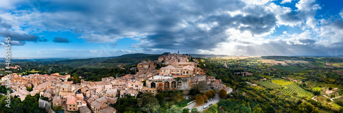 Italy, Province of Siena, Montepulciano, Helicopter panorama of medieval hill town in Val dOrcia at cloudy sunset photo