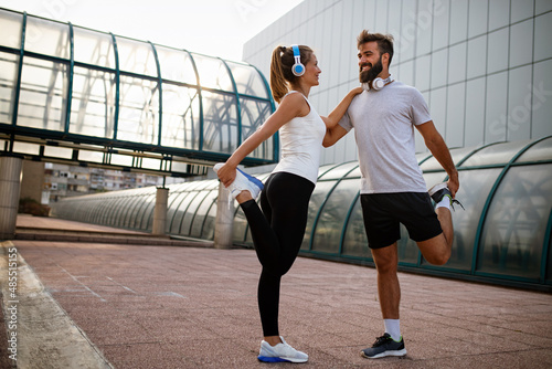 Portrait of happy fit sporty couple exercising and enjoying healthy lifestyle. People sport concept photo