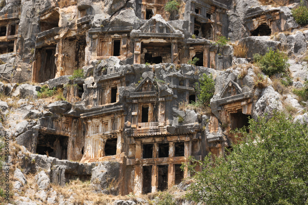 Demre, Antalya, Turkey - June 18 2014: Tombs carved into rocks on cliff at Myra necropolis
