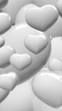 zoom on various size of white shinny hearts in portrait format