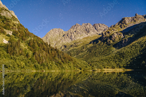 Lake with Caucasus mountain range at night, Sochi, Russia