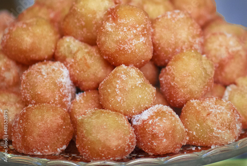 traditional Italian carnival fritters dusted,covered with sugar, filled with custard
