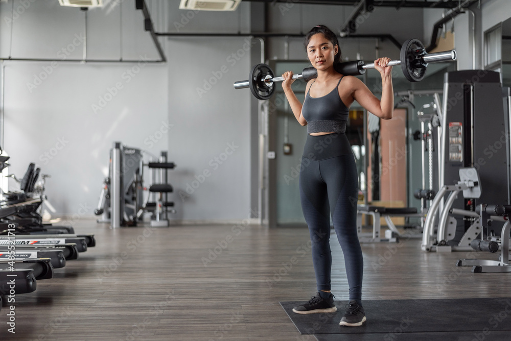 Fototapeta premium Asian woman exercise in fitness. Young healthy woman in sportswear in fitness.