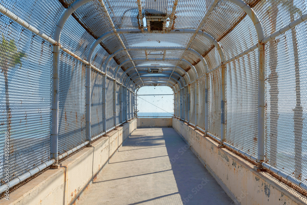 Old covered footbridge with rusty metal roof in San Clemente, California