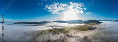 Drone panorama of agricultural fields at foggy sunrise