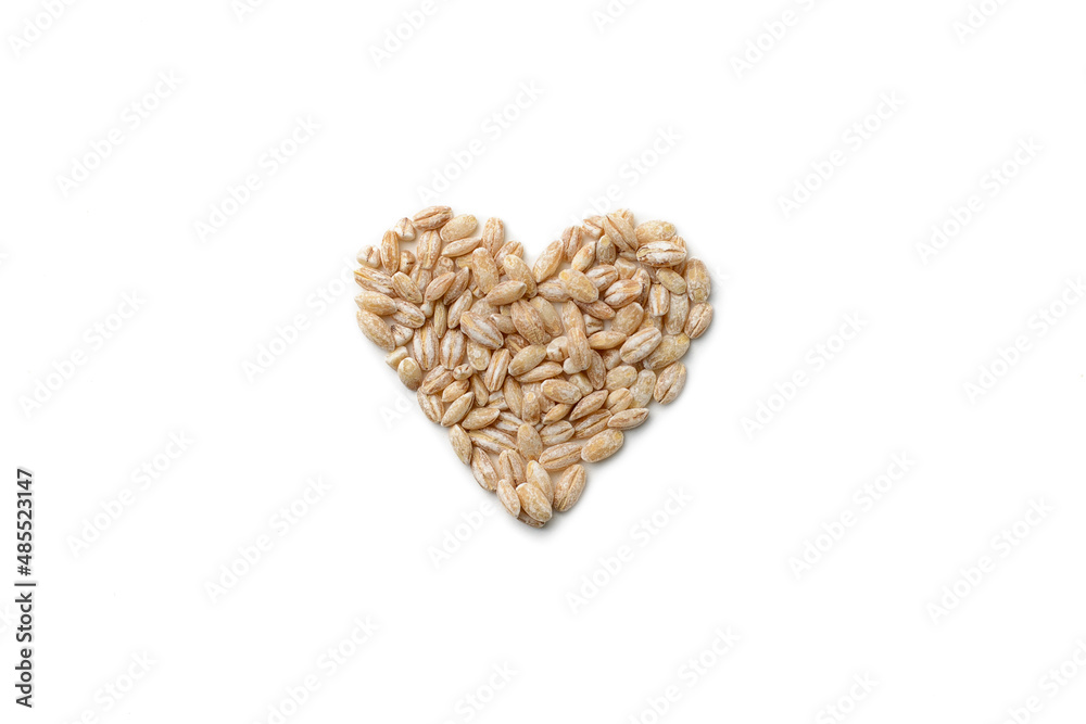 Oat grain folded in the shape of a heart on a white isolated background, top view. Oat grain folded in the shape of a heart on a white isolated background, top view.