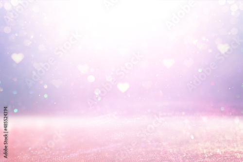 purple and pink glitter vintage lights background. defocused. hearts overlay