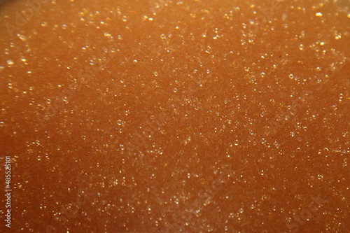 Golden amber softening ion exchange resin background texture photo