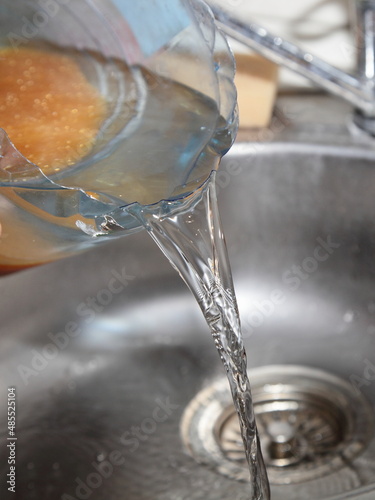 Pouring water softening ion exchange resin in the filter cartridge after regeneration with salt