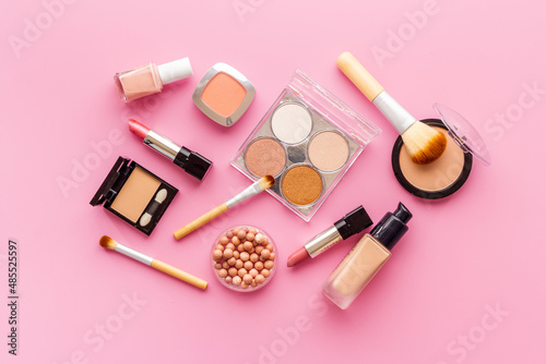 Decorative makeup cosmetic with powder and brushes on color background