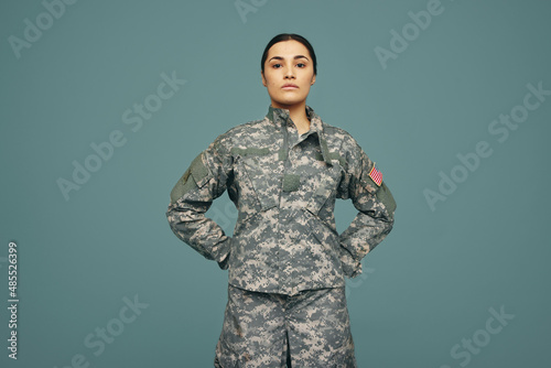 Young American army soldier standing in a studio photo