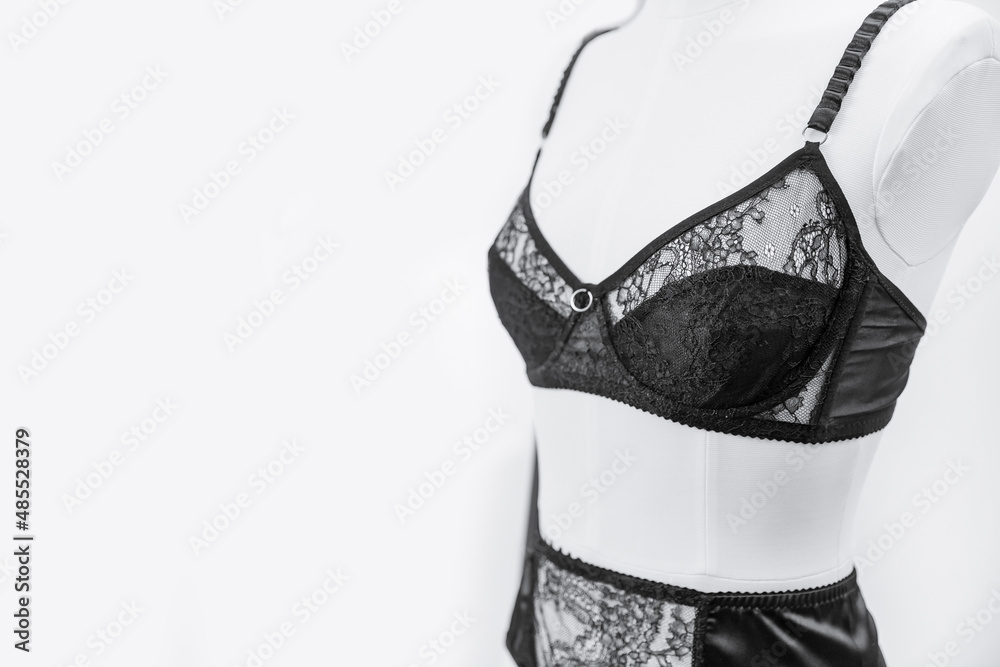 Stylish black lace lingerie underwear on woman mannequin, white background - obrazy, fototapety, plakaty 