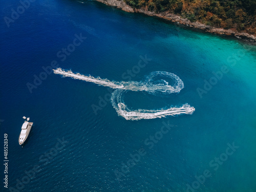 .Top view of the speedboat, leaving trace on the surface of the blue water; vessels concept.. © Semachkovsky 