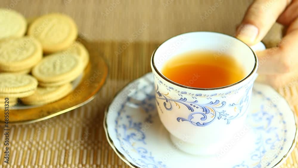 Man is drinking tea with cookies , in studio Chiangmai Thailand. Man is drinking tea with cookies , in studio Chiangmai Thailand.