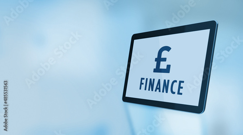 Pound Symbol and Finance Text On A Digital Tablet Screen