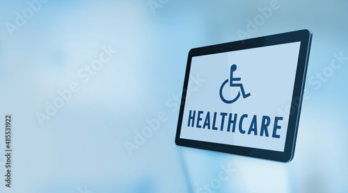 Wheelchair Symbol and Healthcare Text On A Digital Tablet Screen