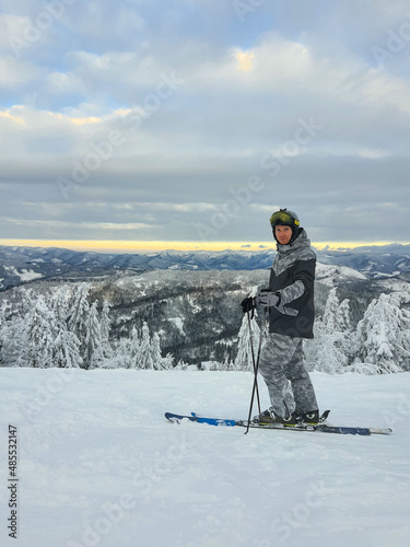 man skier enjoying sunset above the mountains