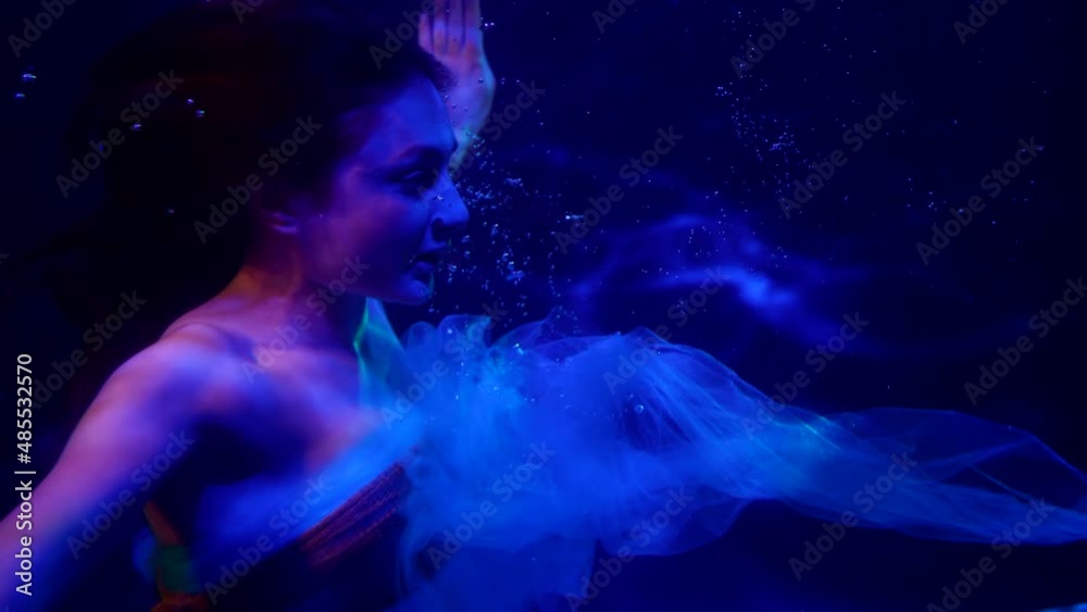 charming sexy mermaid is swimming underwater, closeup of her face and body, mysterious female figure charming sexy mermaid is swimming underwater, closeup of her face and body, mysterious female figure