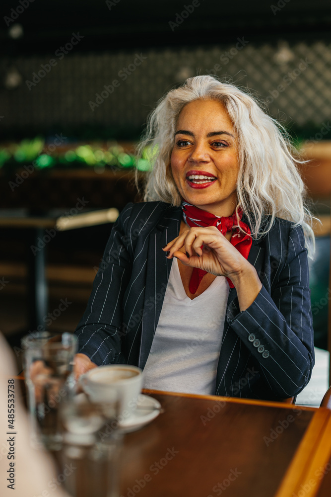 Smiling middle age confident businesswoman at coffee break Smiling middle age confident businesswoman at coffee break