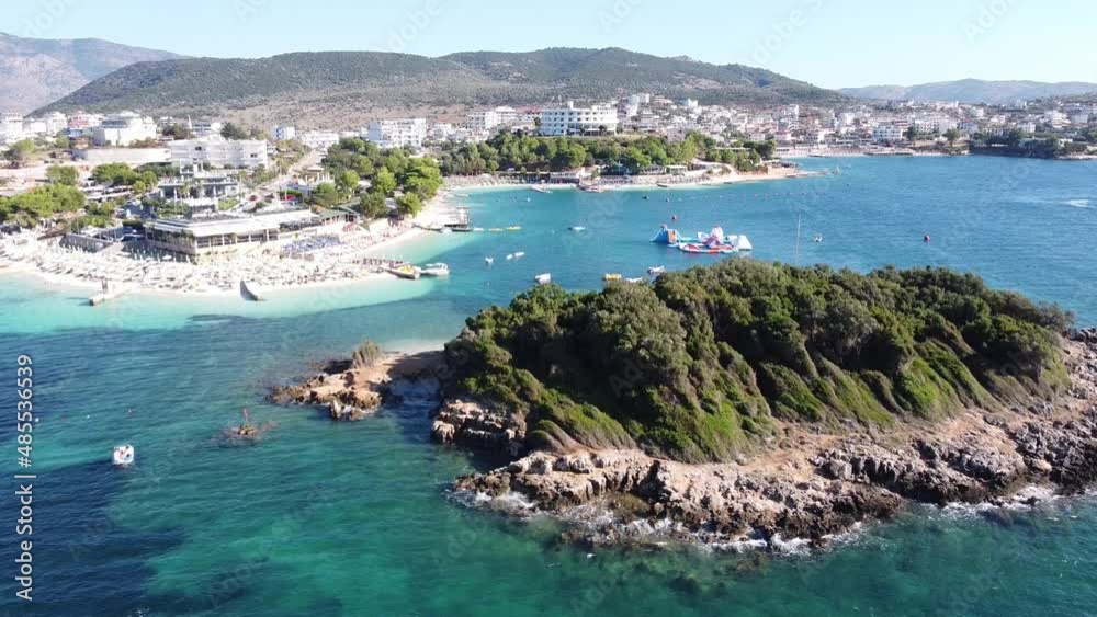 Aerial Drone View of Ksamil Beach, Ionian Sea, Albania - Island, Sunbeds, Boats, Hotels, Resorts, Mountains and Water Playground Aerial Drone View of Ksamil Beach, Ionian Sea, Albania - Island, Sunbeds, Boats, Hotels, Resorts, Mountains and Water Playground