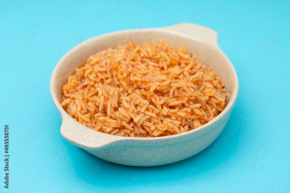 tomato rice on the dish on blue background