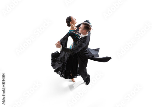 Viennese waltz. Young graceful artistic couple, man and woman dancing ballroom dance isolated over white studio background. Beauty, art, sport concept