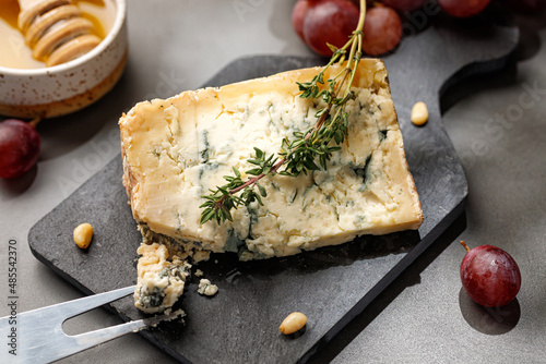 Cheese platter with gorgonzola cheese, rosemary, honey and fork. photo