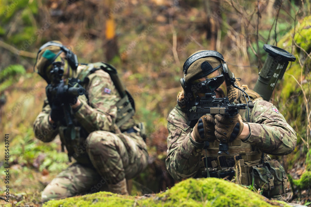 Fototapeta premium Madam led British special force duo aiming to kill in the woods . High quality photo