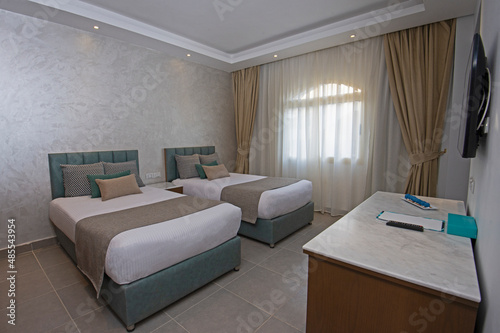 Twin beds in suite of a luxury hotel room