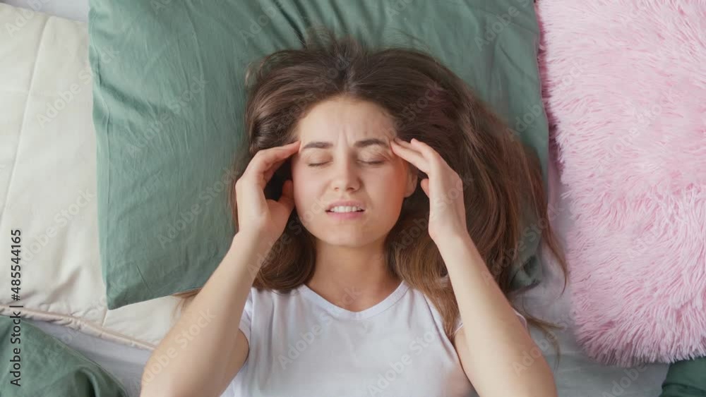 A Young Woman Wakes Up in a Bad Mood in an Bed At Home