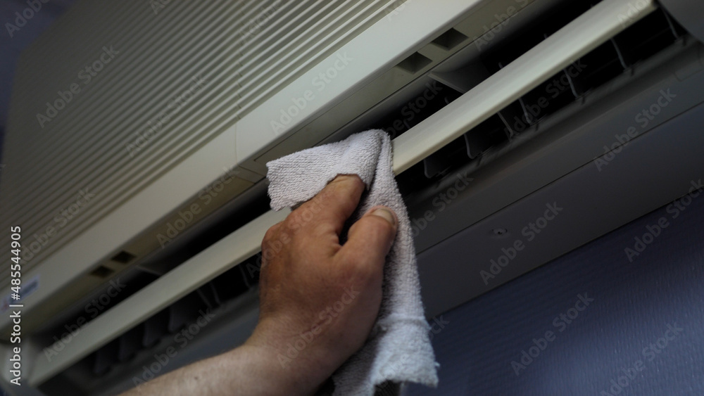 Technician service cleaning the air conditioner indoors. Close up