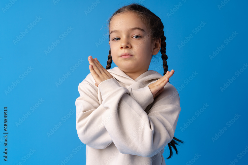 Portrait of upset little girl on blue background Portrait of upset little girl on blue background