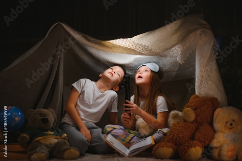 Valokuvatapetti Little children reading bedtime story at home