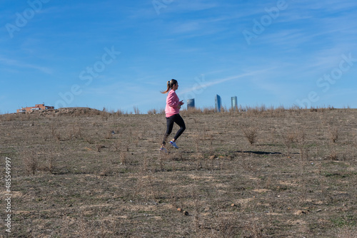 Woman running in the bush. Pink clothes. Active life. sport in the morning