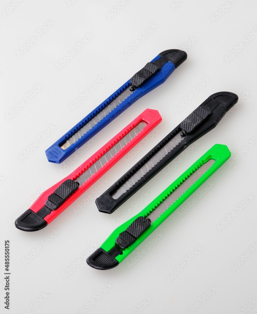 Colored paper knife on white background Colored paper knife on white background