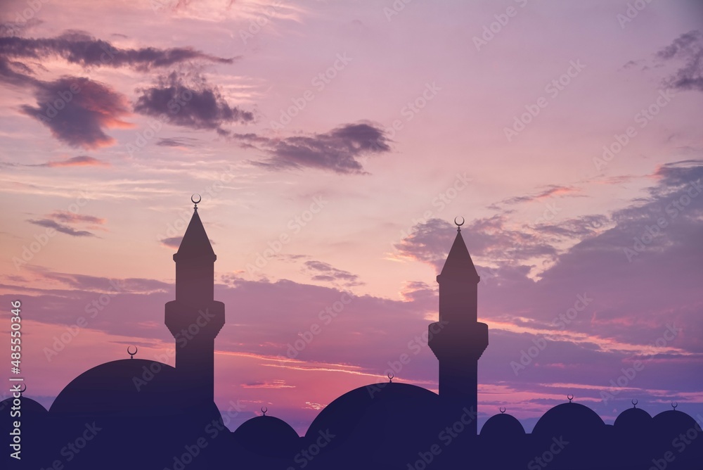 silhouette of a beautiful mosque against the background of sunset sun