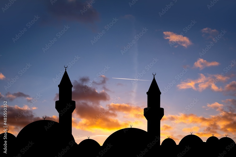 silhouette of a beautiful mosque against the background of sunset sun