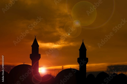 Obraz na płótnie silhouette of a beautiful mosque against the background of sunset sun w salonie