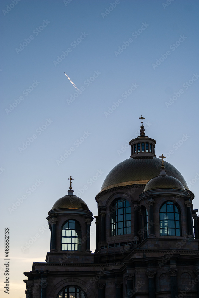 Plane over church domes