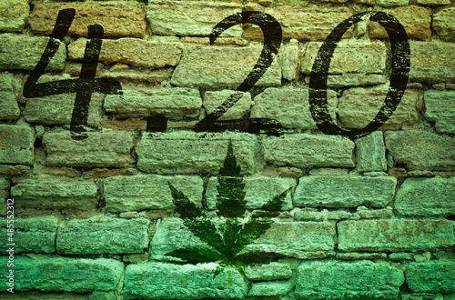 Happy 4:20 Marijuana Leaf, Cannabis Celebration. Text on an old stone wall. Photo montage