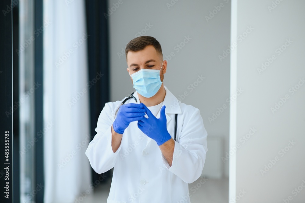 Portrait of male doctor wearing surgical mask is ready to help patients with coronavirus or covid virus.