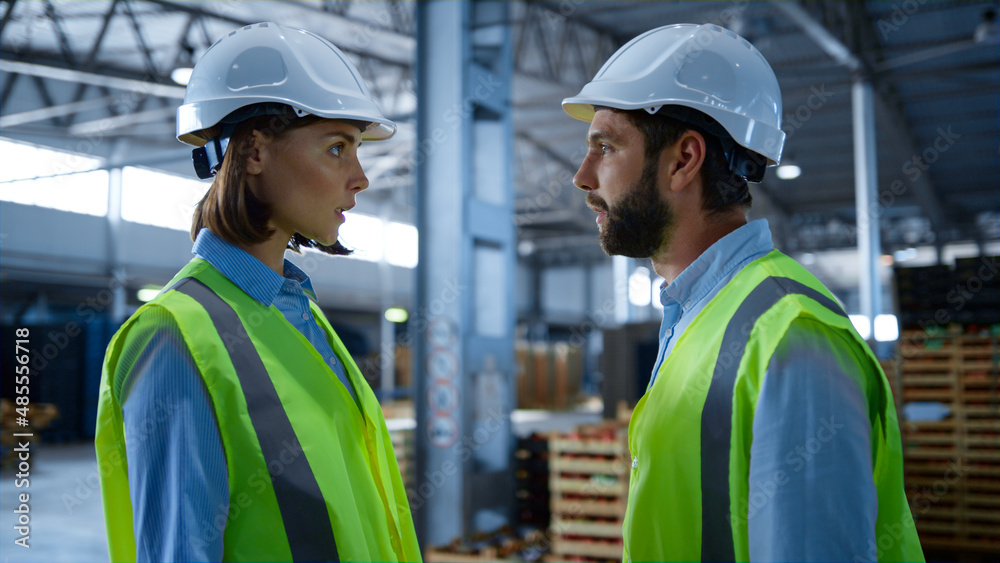 Factory workers shaking hands discussing production inspecting warehouse Factory workers shaking hands discussing production inspecting warehouse