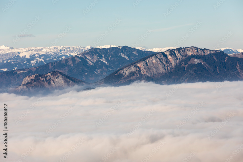 mountain peaks Roethelstein and Rote Wand above sea of fog in Styria, Austria