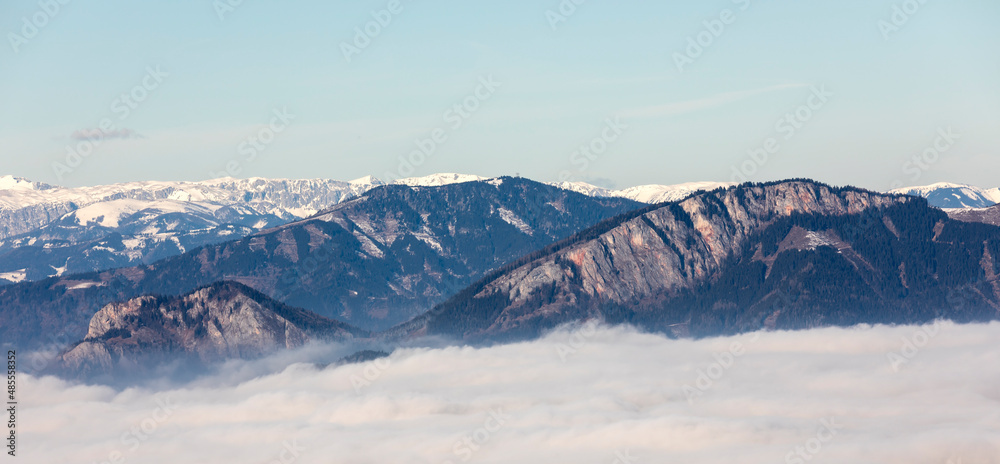 mountain peaks Roethelstein and Rote Wand above sea of fog in Styria, Austria