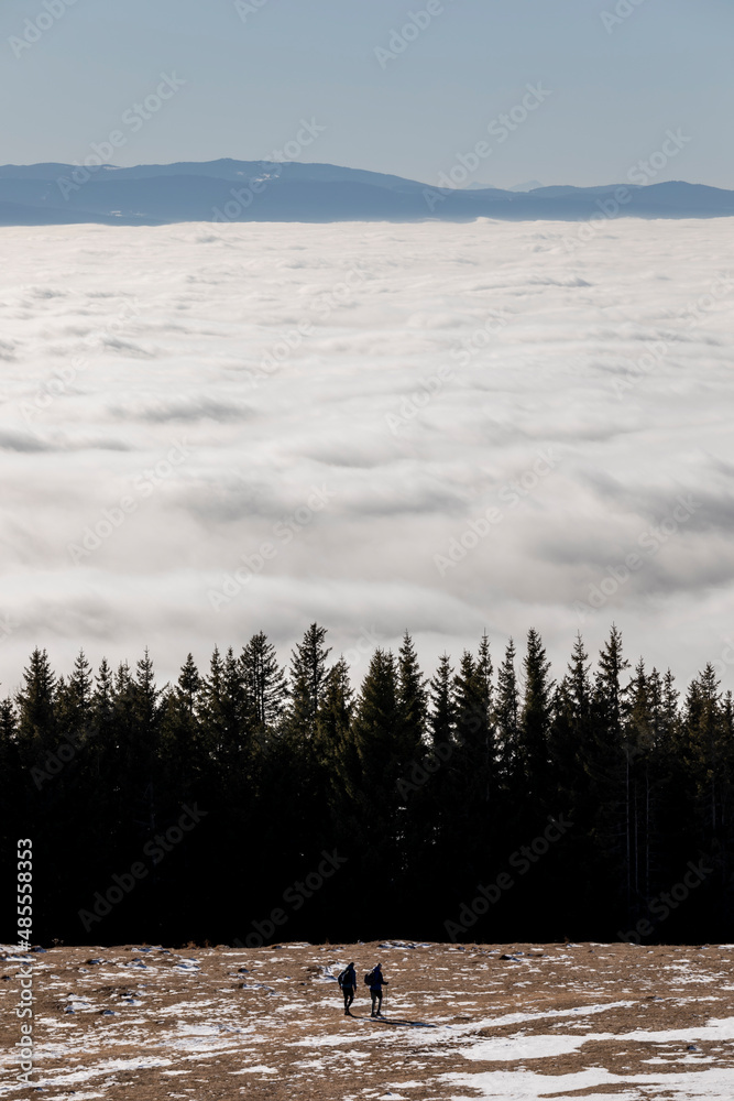 Wanderer above the Sea of Fog on mountain Schoeckl near Graz, Austria