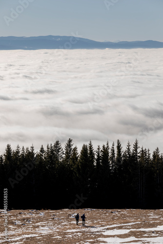 Wanderer above the Sea of Fog on mountain Schoeckl near Graz, Austria